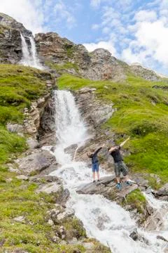 A father and son at the alpine waterfall Stock Photos