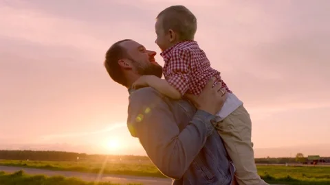 Father and son are playing together at sunset Stock Footage 78852661