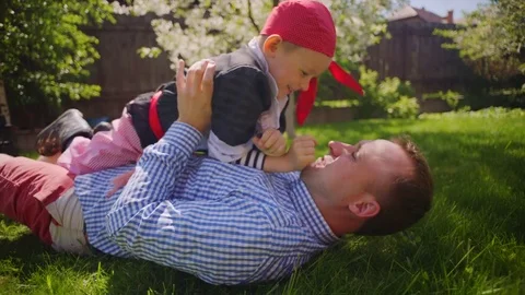 Father and son are playing on the lawn Stock Footage 80230461
