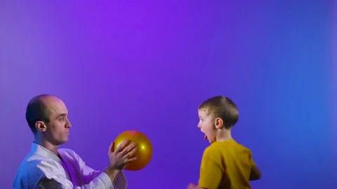 Father and son are practicing kicking the ball Stock Footage 235105549