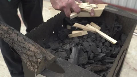Father and son are preparing barbecue grill and put wood on coals Stock-Footage 128802152