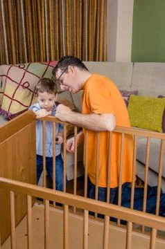 Father and son assembling cot for a newborn at home Stock Photos
