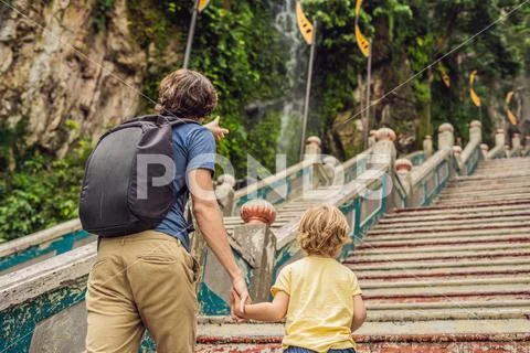 Father and son in the background of Batu Caves, near Kuala Lumpur, Malaysia. Stock Photos