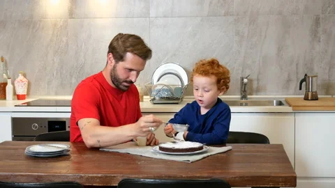 Father and son baking cake in kitchen 스톡 동영상 135169713