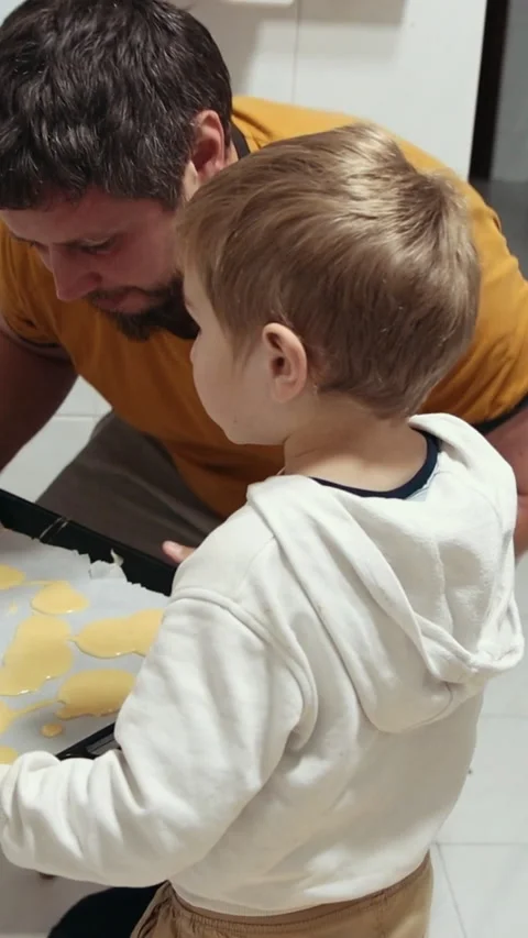 Father and son baking cookies at home Stock Footage 327291476