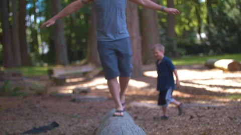 Father and Son Balancing on a Log Stock Footage 91592014