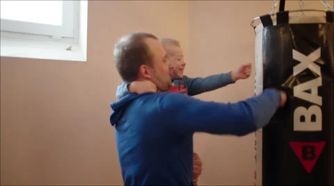 Father and Son Beating Punching Bag Stock Footage 60388656