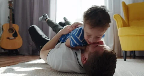 A father and son bond through play in their cozy living room Stock Footage 306847856