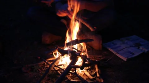 Father and son burning stick in a small campfire Stock Footage 44446837