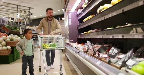 Father and son buying fruit and vegetable in grocery store Stock Footage 73511029
