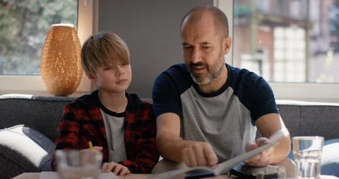 Father and son do homework together Stock Footage 128836850