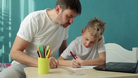Father and son do homework remotely in front of notebook Video stock 149813599
