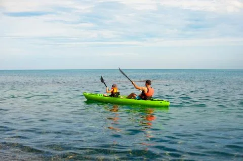 Father and son do kayaking at the lake with beautiful natural background Stock Photos