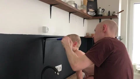 Father and son doing house renovations Stock Footage 202082560