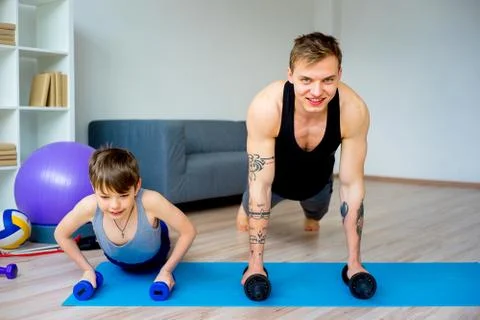 Father and son doing push ups Stock Photos