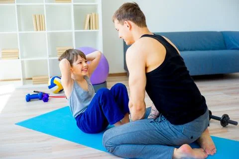 Father and son doing sit ups Stock Photos