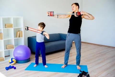 Father and son doing stretching together Stock Photos