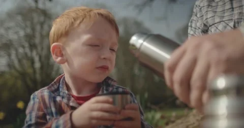 Father and Son drink tea from flask together Stock Footage 60793876