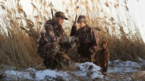 Father and son duck hunting Stock Footage