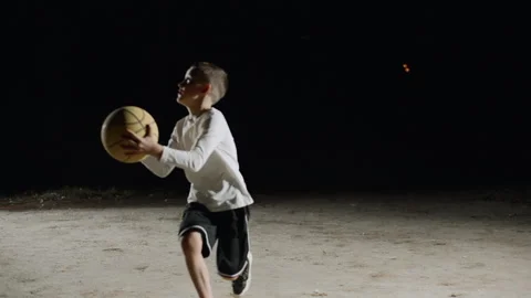 Father and son enjoy a friendly basketball game at night Stock Footage 284212222