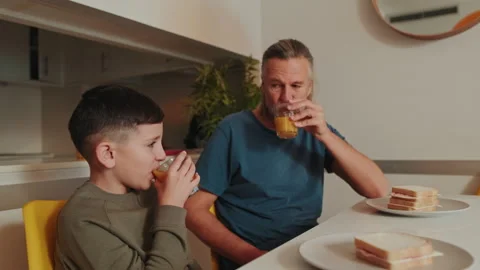 Father And Son Enjoying Breakfast Together At Home Stock Footage 345165873