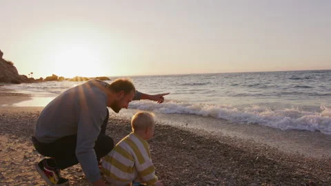 Father and son enjoying sunset moments at the beach Stock Footage 225537235