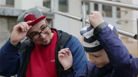Father and son exchanging their caps Stock Footage 67170666