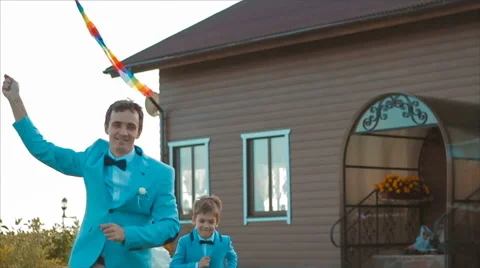 Father and Son Fly a Kite in the Yard Stock Footage 68907136