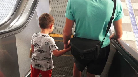 Father and son go down the escalator Stock Footage 101739655