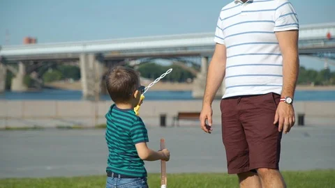 Father and Son Having Fun with Soap Bubbles Stock Footage 115067033