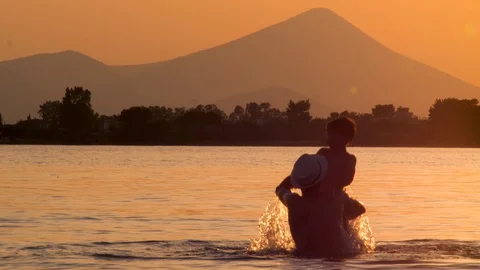 Father and son having fun in the water, sea on dusk on background. Happy father Stock-Footage 116502908