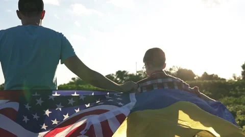 Father and son hold American and Ukrainian flags. Symbol of US support for Stock Footage 278162753