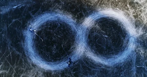 Father and son ice skating circles, infinity symbol Stock Footage 123588697