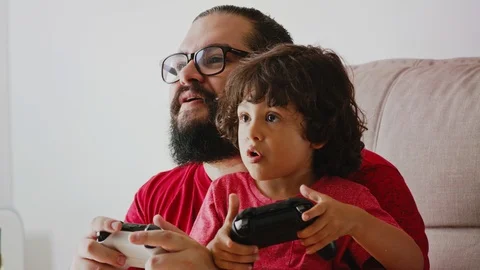 Father And Son Interacting Having Fun Playing Video Game Together Stock Footage 98776185