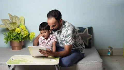 Father and Son Learning on Tablet Together Stock Footage 339485234