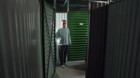 Father and Son Loading Boxes inside Self Storage Unit Video stock 327783213