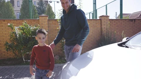 The father and son looking under the car hood Stock Footage 117734891