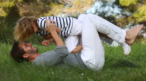 Father and son lying and playing in the meadow Stock Footage 57380264