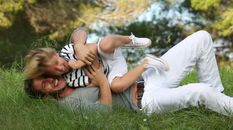 Father and son lying in the grass having fun Stock Footage 57378546