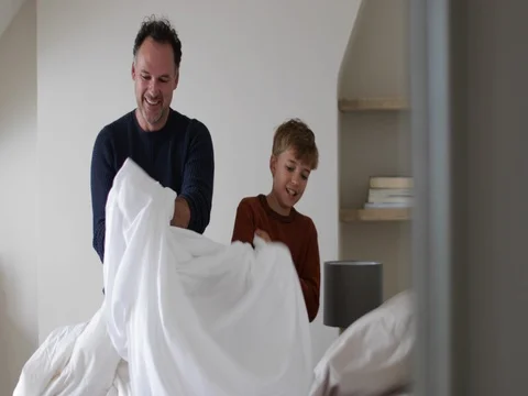 Father and Son making a bed Stock Footage 80368482
