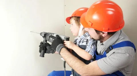 Father and son with one drill in wall. Stock Footage 58953157