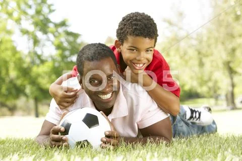 Father And Son In Park With Football Stock Photos