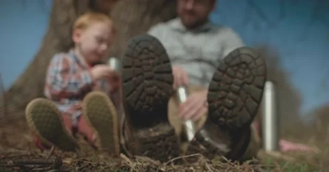 Father and Son picnic under tree Stock Footage 60793859