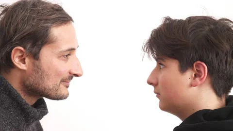 Father and son play a game of who will review whom. The son wins. Family values. Stock Footage 232993889