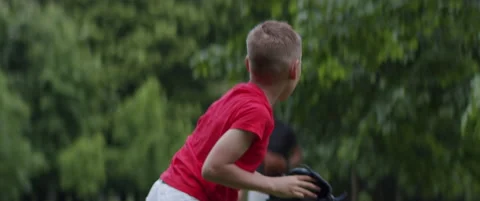 Father and son playing baseball catch in the park on a rainy day. Family time Stock Footage 132690793