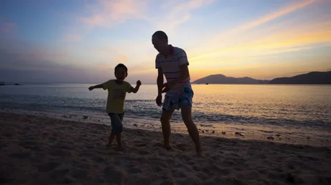 Father and son playing on the beach in sunset:4K timelapse Stock Footage 54637271