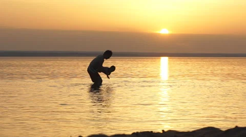 Father and Son Playing on the Beach at Sunset Stock Footage 68016482