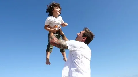 Father and son playing on the beach Stock Footage 79183487