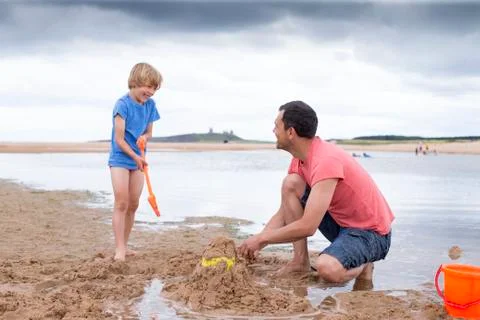 Father and son playing on the beach Foto stock