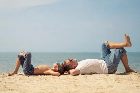 Father and son playing on the beach at the day time. Stock Photos